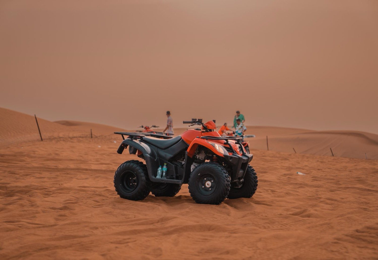 Quad trails · dust and dunes at sunset